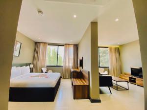 a hotel room with a large bed and a tv at New Amaan Hotel in Zanzibar City +17 photos