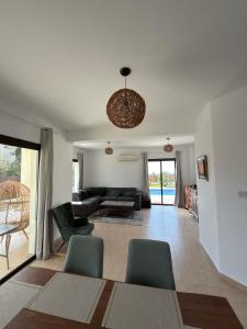 a living room with a couch and a table and chairs at Casa Elea in Kouklia