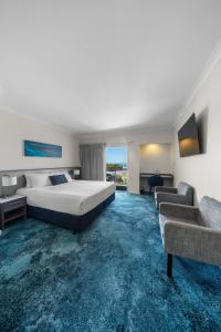 a hotel room with a bed and a couch at Ocean Centre Hotel in Geraldton +22 photos