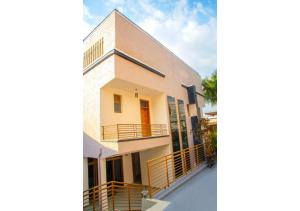 a rendering of a house with a balcony at Macchiato Suites Boutique Hotel in Kigali