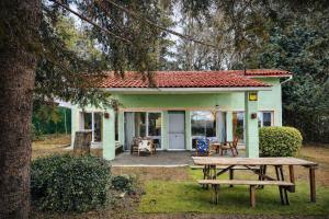 a small house with a picnic table in front of it at El Pinsapo in Segovia