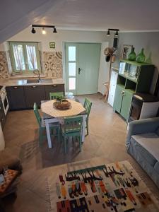 a kitchen and living room with a table and chairs at Hiža Bepina in Marčana +23 photos