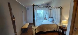 a bedroom with a canopy bed in a room at Villa Desideri Agriturismo Dinoabbo in Lucinasco +45 photos