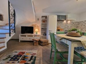 a kitchen with a table and a refrigerator at Hiža Bepina in Marčana