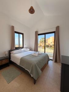 a bedroom with a bed and a large window at Casa Elea in Kouklia +22 photos