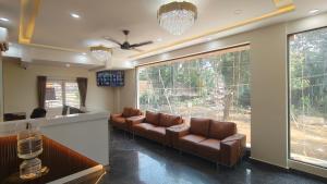 a waiting room with couches in front of a window at COMFORT Inn in Subrahmanya