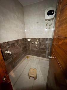 a bathroom with a toilet and a sink at Karshni Kuteer in Mathura