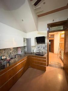 a kitchen with a sink and a counter top at Karshni Kuteer in Mathura