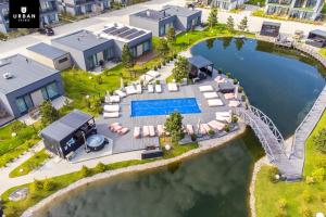 an aerial view of a house with a pool and a bridge at Harmony Shore Apartments in Palanga