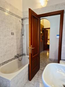 a bathroom with a tub and a sink at Quiet Tortellini in Modena +72 photos