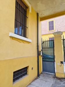 a yellow building with a door and a window at Quiet Tortellini in Modena