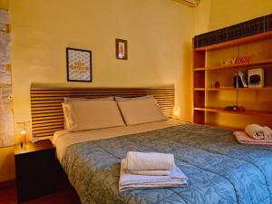 a bedroom with a bed with towels on it at Quiet Tortellini in Modena