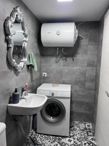 a bathroom with a washing machine and a sink at Sofisstudios in Mytilene +10 photos