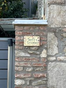a sign that says soft studios on a brick wall at Sofisstudios in Mytilene