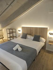 a large bed with two pillows on top of it at Hotel Puerta de la Serrania in Lliria +47 photos