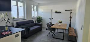 a living room with a couch and a table at Apartment nahe München A8 in Pfaffenhofen an der Glonn