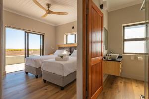 a bedroom with a bed and a window at Quagga River Lodge in Velddrif