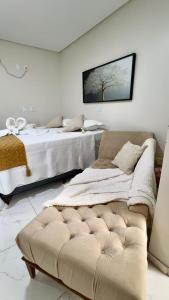 a bedroom with two beds and a couch in it at Hotel Pedra da Letra in Mauriti