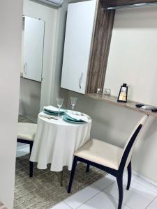 a white table with two chairs and a mirror at Hotel Pedra da Letra in Mauriti