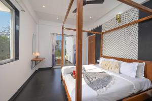 a bedroom with a four poster bed and a window at 6BHK White Castle Villa in Malavli +38 photos