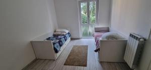 a small room with a bed and a window at Melis Apartment in Como