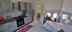 a kitchen with a sink and a table in it at Melis Apartment in Como