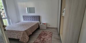 a small bedroom with a bed and a window at Melis Apartment in Como
