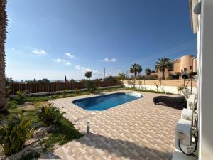 a swimming pool in a yard with a house at Casa Elea in Kouklia