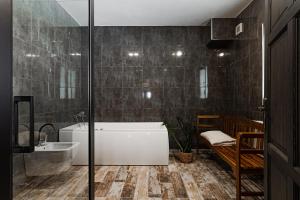 a bathroom with a bath tub and a sink at Villa Pontis Rabštejn nad Střelou in Rabštejn nad Střelou