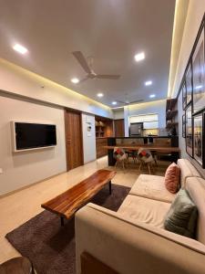 a living room with a couch and a table at Skyline Serenia 23rd floor in Dehu Road