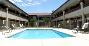 a swimming pool in front of a building at Premier Inns Tolleson in Phoenix