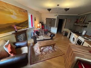 a living room with a couch and a coffee table at Hay View Lodges - Barn End in Hay-on-Wye
