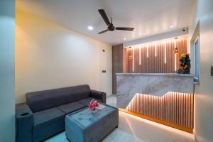 a living room with a couch and a table at Open Hotel by Olive - Urban Suites in Bangalore
