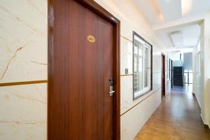a wooden door in a hallway with a window at Open Hotel by Olive - Urban Suites in Bangalore +15 photos