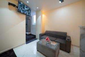 a living room with a couch and a table at Open Hotel by Olive - Urban Suites in Bangalore