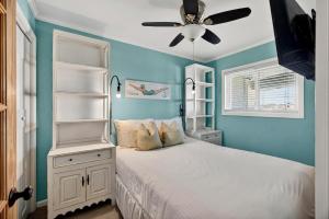 a bedroom with a white bed and a ceiling fan at SC304A: 304A Sea Cabin in Isle of Palms +30 photos