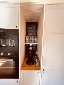 a kitchen with a cupboard with a coffee maker in it at Bernstorfshof in Jübek