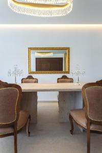 a large table with two chairs and a mirror at Orama Estate in Koskinou +44 photos