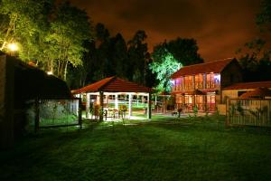 a group of buildings at night with lights at Quinta da Costa in Lixa