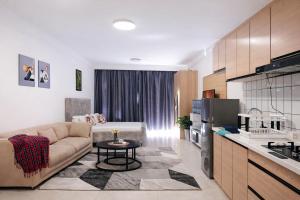 a living room with a couch and a kitchen at Little Haven Stays-Near UN & Two Rivers in Ruaka