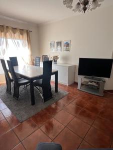 a dining room with a table and a television at Casa do Rodrigo in Mondim de Basto