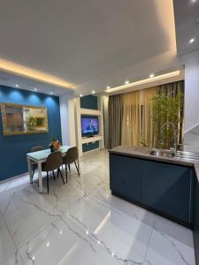 a kitchen and dining room with a sink and a table at B&S Accommodation Newly Renovated Penthouse 253 in Żejtun