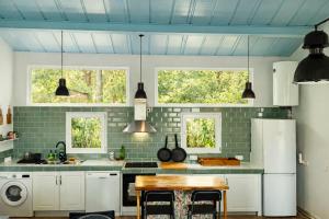 a kitchen with white cabinets and a blue ceiling at El Pinsapo in Segovia