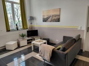 a living room with a couch and a tv at Ferienwohnung CityImmo in Gotha