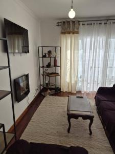 a living room with a couch and a coffee table at LandS in Caniço