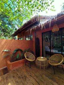 a patio with two chairs and a table at Terracotta tropical nest in San Vicente +4 photos