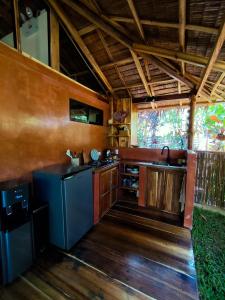 a kitchen with a stove and a sink in a room at Terracotta tropical nest in San Vicente