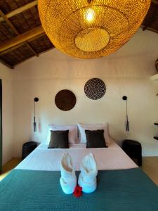 a bedroom with a bed with white shoes on it at Terracotta tropical nest in San Vicente