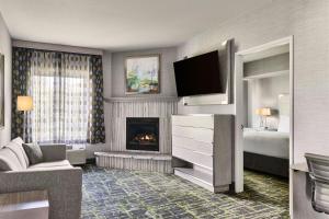 a living room with a fireplace and a television at SpringHill Suites Prescott in Prescott