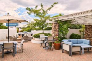 a patio with tables and chairs and an umbrella at SpringHill Suites Prescott in Prescott